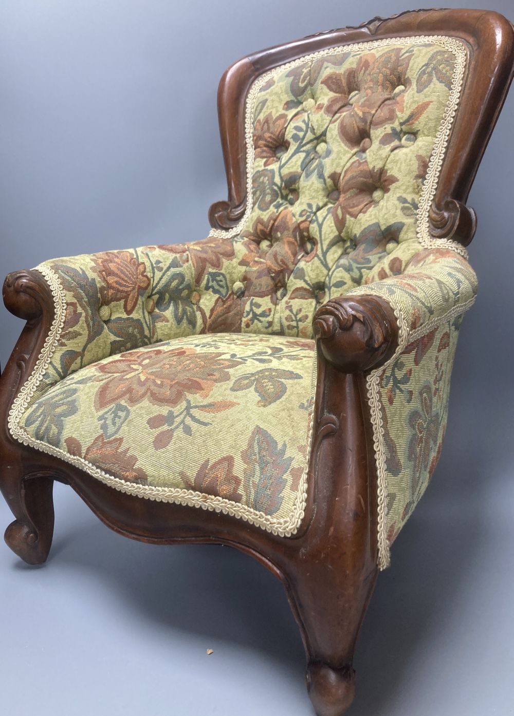 A reproduction miniature spoonback armchair